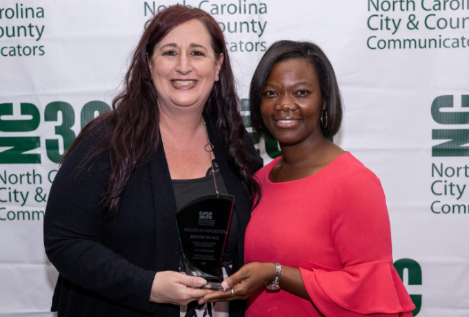 Communications and Marketing Manager Dana Kaminske accepts the award from NC3C President Kaisha Brown