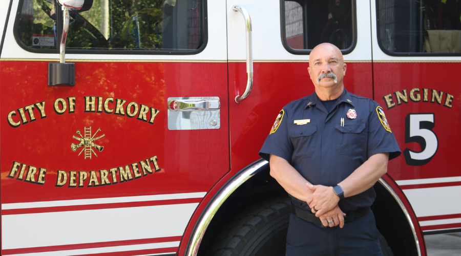 Fire Captain Doug Price stands in front of fire engine