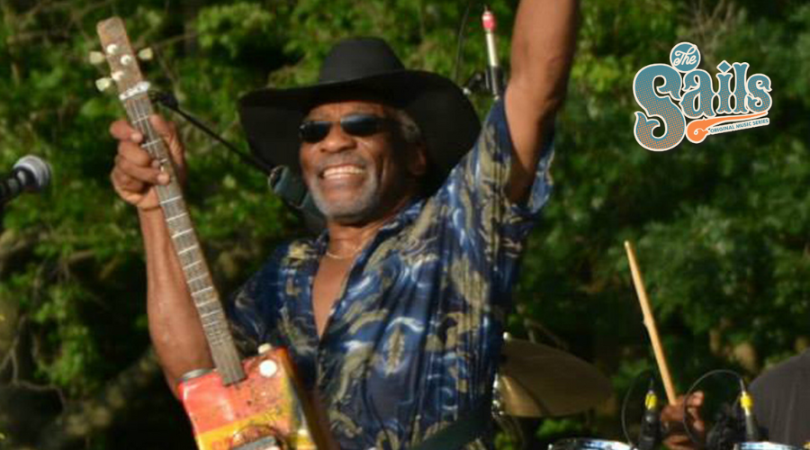 Mac Arnold holding a gas can guitar