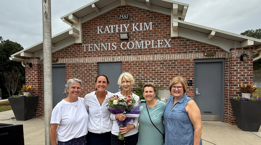 Kathy Kim and others standing in front of the Kathy Kim Tennis Complex