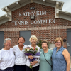 Kathy Kim and others standing in front of the Kathy Kim Tennis Complex